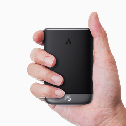 Gray Glow Air hand warmer held in one hand, showing palm-sized ergonomic fit
