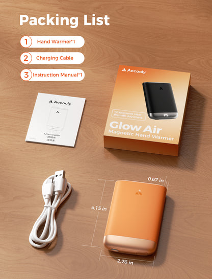 Packing list of the orange Glow Air hand warmer: unit, USB charging cable and user guide, measuring 4.15 x 2.76 x 0.67 in
